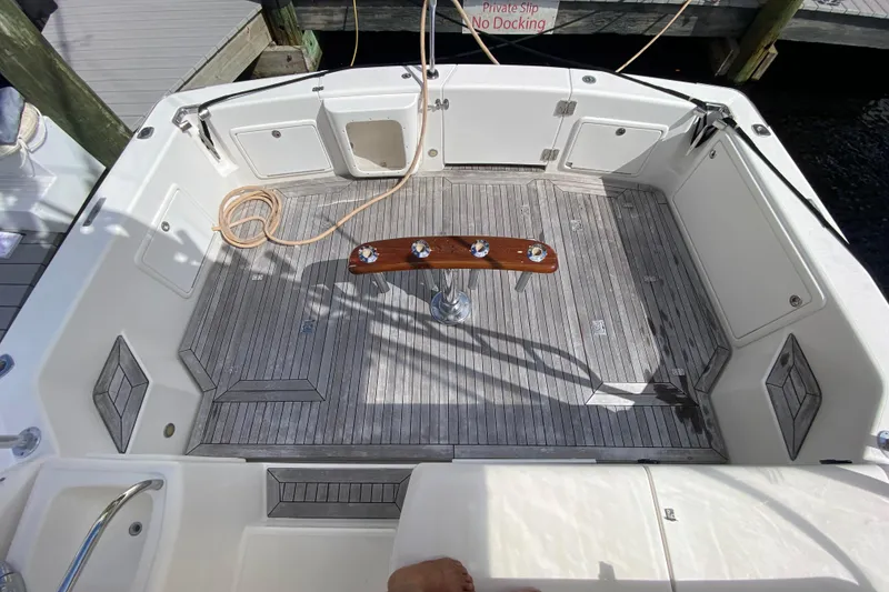 Slide: The Image of Spacious deck of 2000 Riviera 4000 yacht with wooden flooring and fishing rod holders. - 3