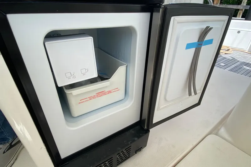 Slide: The Image of Open refrigerator on Riviera 4000 yacht, showcasing ice maker and storage compartment. - 39