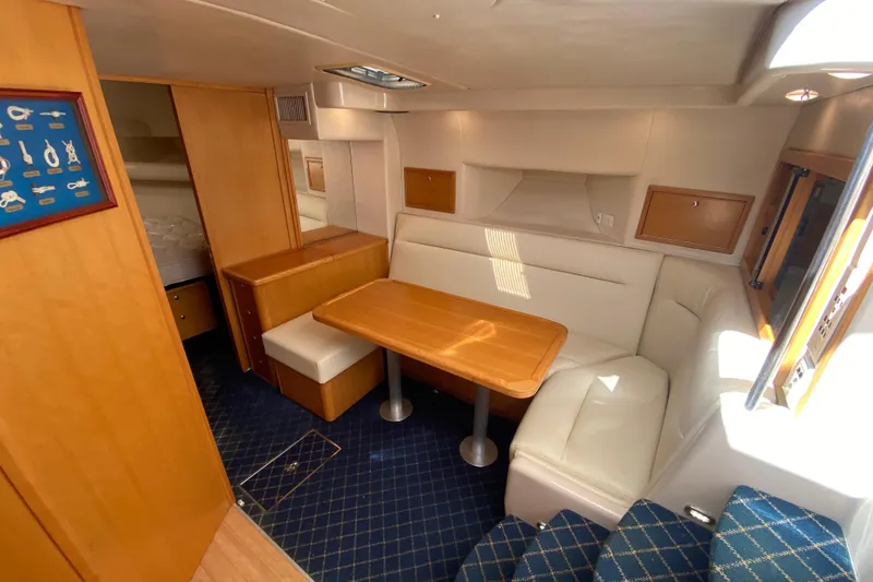 Slide: The Image of Luxurious interior of 2000 Riviera 4000 yacht with cozy seating and wooden table. - 43