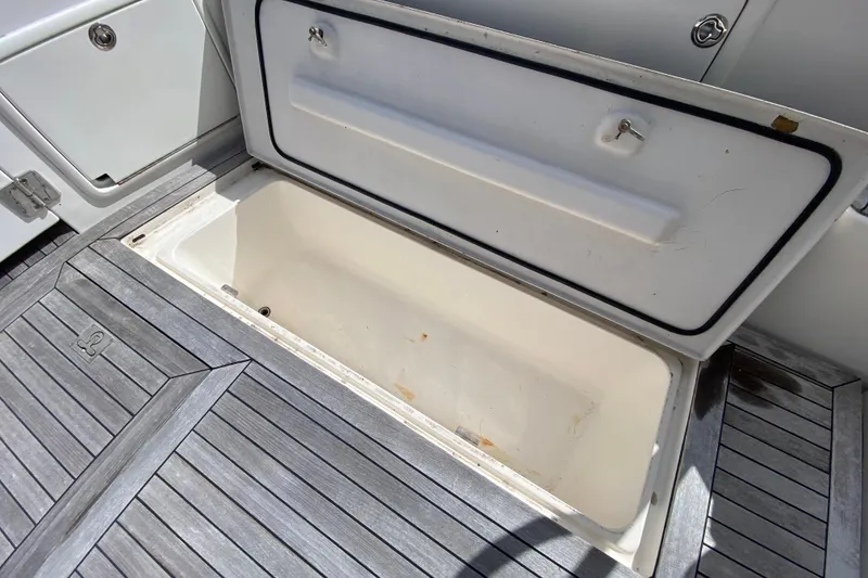Slide: The Image of Open storage compartment on 2000 Riviera 4000 boat with wooden deck. - 5