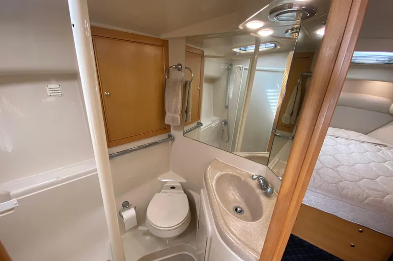Slide: The Image of Compact bathroom in 2000 Riviera 4000 yacht with sink, toilet, and shower. - 55
