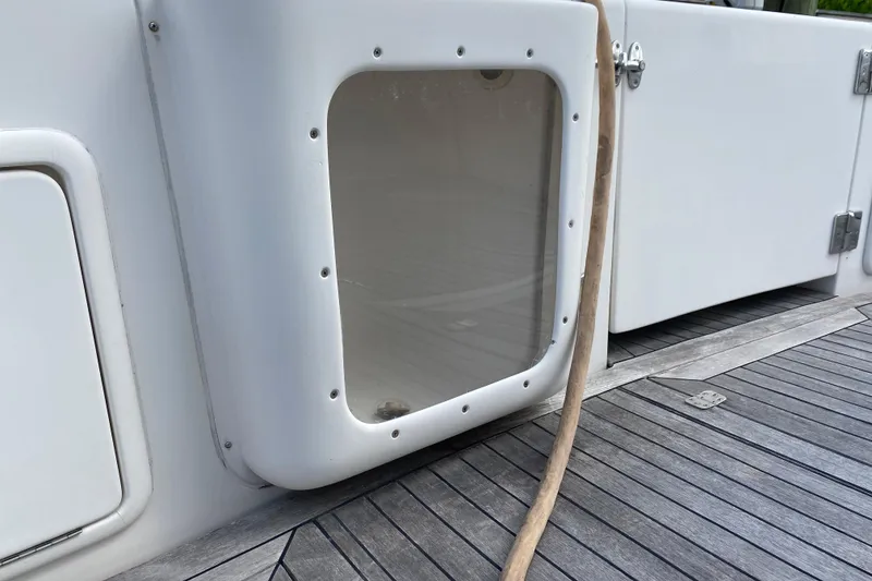 Slide: The Image of Riviera 4000 yacht deck detail, featuring a white panel and wooden flooring, 2000 model. - 8