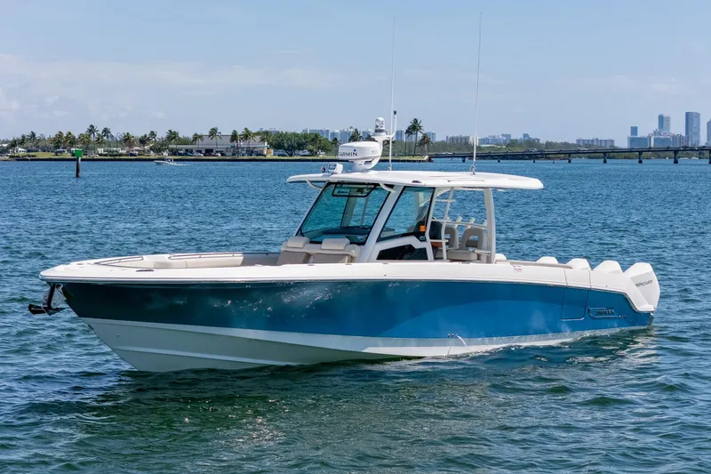 The Image of 2022 Boston Whaler 380 Outrage boat on calm water, city skyline in background. - 0