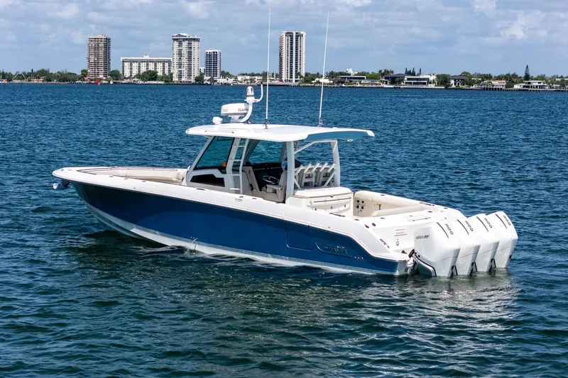 Slide: The Image of 2022 Boston Whaler 380 Outrage boat on water with city skyline background. - 11