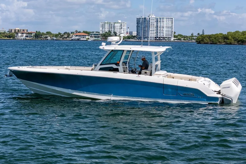 Slide: The Image of 2022 Boston Whaler 380 Outrage boat cruising on a sunny day in coastal waters. - 12