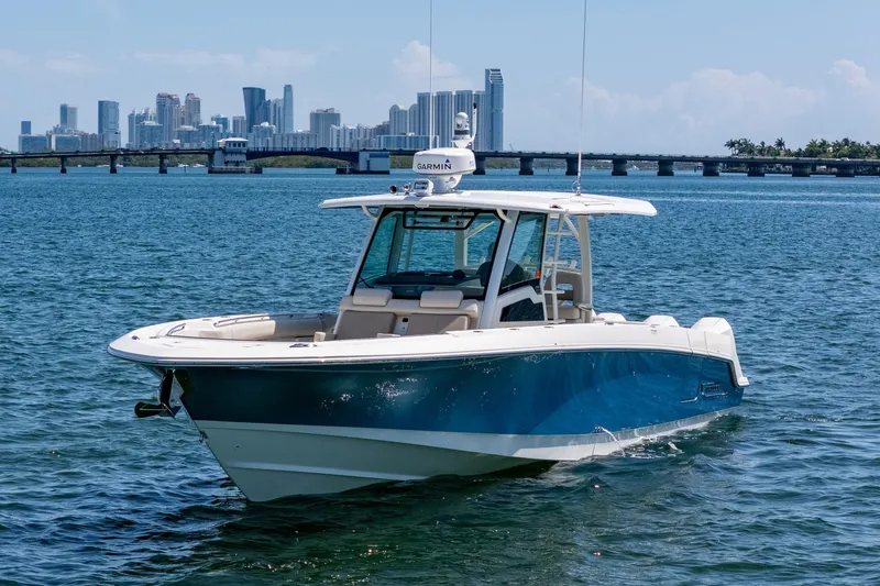 Slide: The Image of 2022 Boston Whaler 380 Outrage boat on water with city skyline background. - 15