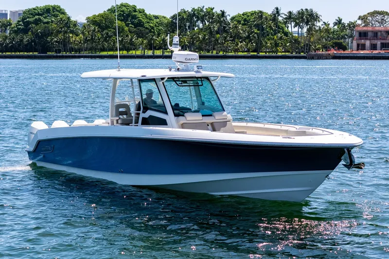 Slide: The Image of 2022 Boston Whaler 380 Outrage boat cruising on a sunny day. - 16
