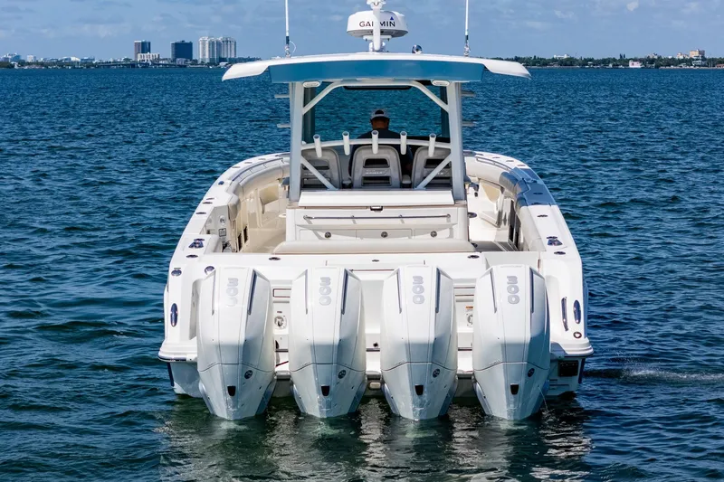 Slide: The Image of 2022 Boston Whaler 380 Outrage with quad engines cruising on open water. - 21