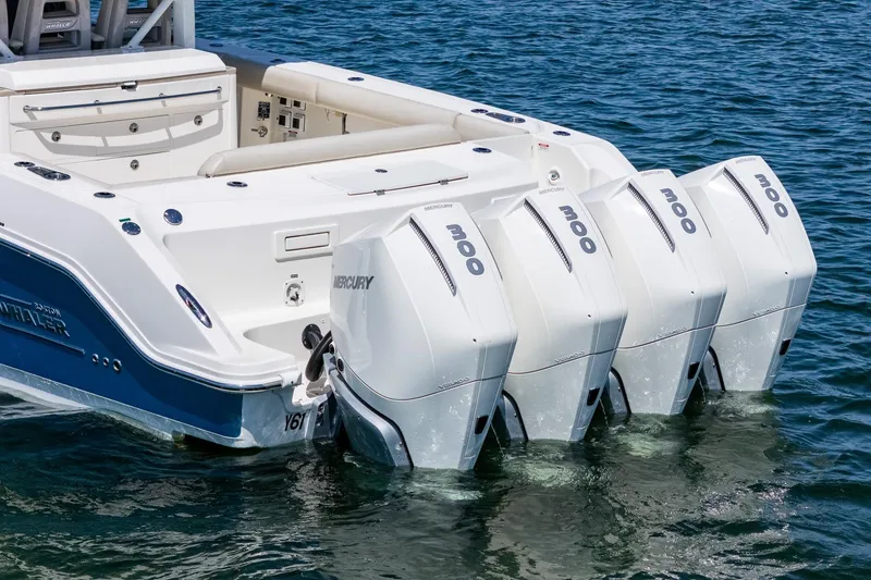 Slide: The Image of 2022 Boston Whaler 380 Outrage with four Mercury outboard engines on the water. - 23