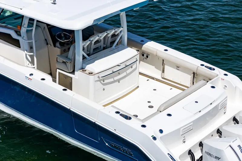 Slide: The Image of 2022 Boston Whaler 380 Outrage boat, featuring spacious deck and modern design on water. - 24