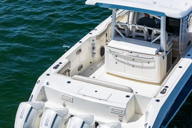 Slide: The Image of 2022 Boston Whaler 380 Outrage boat on water, showcasing spacious deck and seating. - 25