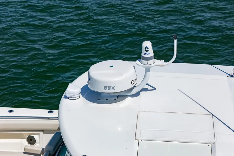 Slide: The Image of 2022 Boston Whaler 380 Outrage with advanced radar and navigation equipment on deck. - 27
