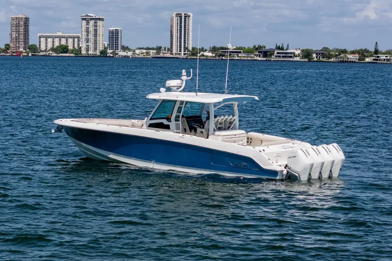 Slide: The Image of 2022 Boston Whaler 380 Outrage boat on water with city skyline in background. - 3