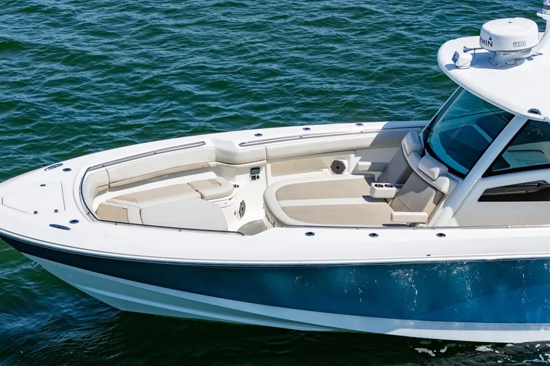 Slide: The Image of 2022 Boston Whaler 380 Outrage boat on water, featuring sleek design and spacious seating. - 30