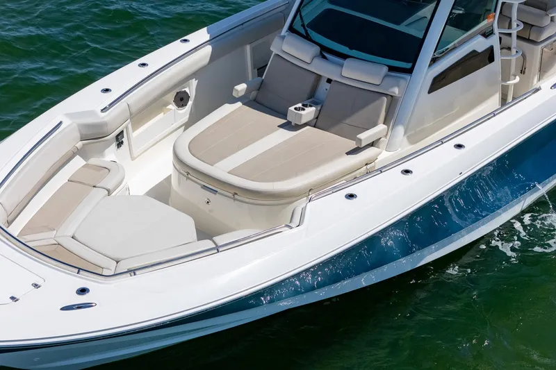 Slide: The Image of 2022 Boston Whaler 380 Outrage boat with spacious seating on calm water. - 31