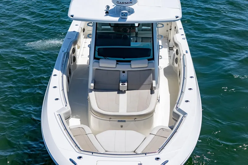 Slide: The Image of 2022 Boston Whaler 380 Outrage boat on water, showcasing spacious seating and sleek design. - 32
