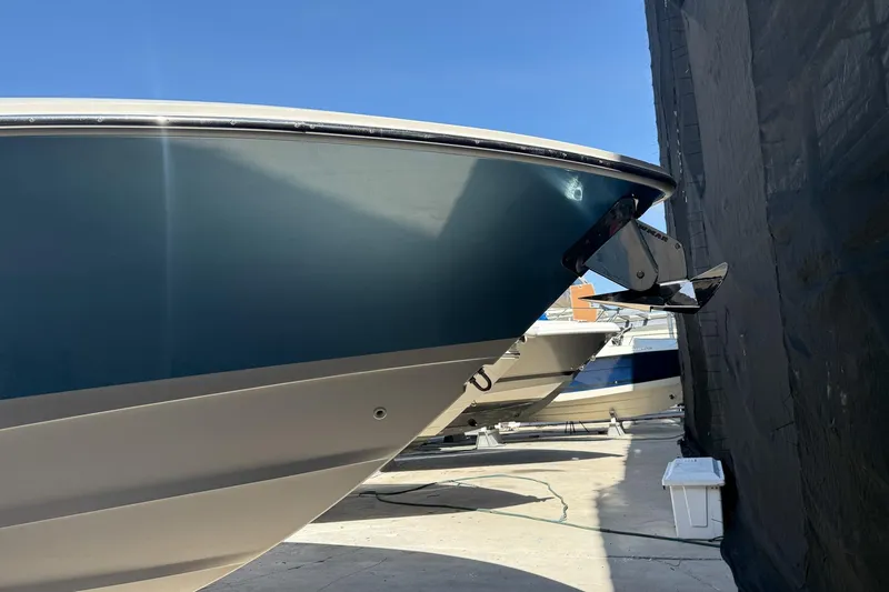 Slide: The Image of 2022 Boston Whaler 380 Outrage boat in storage, side view under clear blue sky. - 44