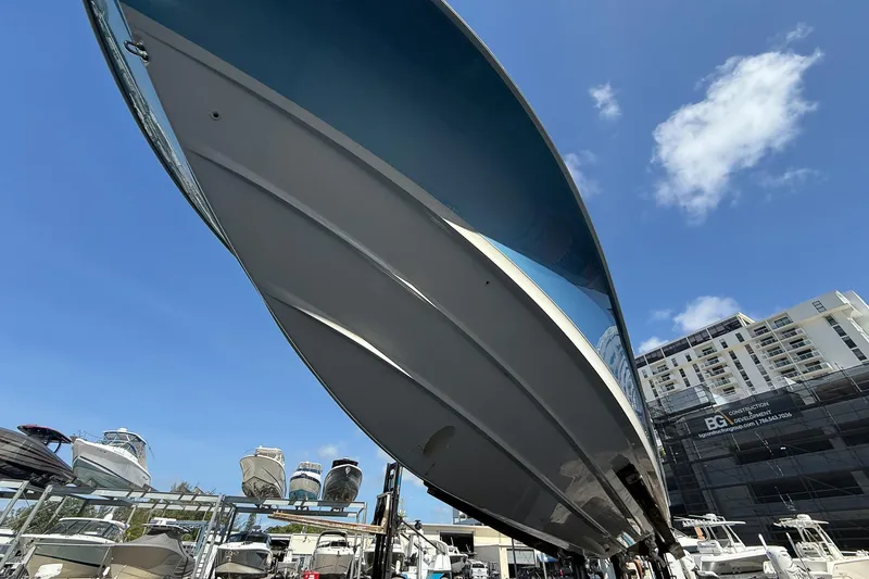 Slide: The Image of 2022 Boston Whaler 380 Outrage boat displayed in marina under clear blue sky. - 48