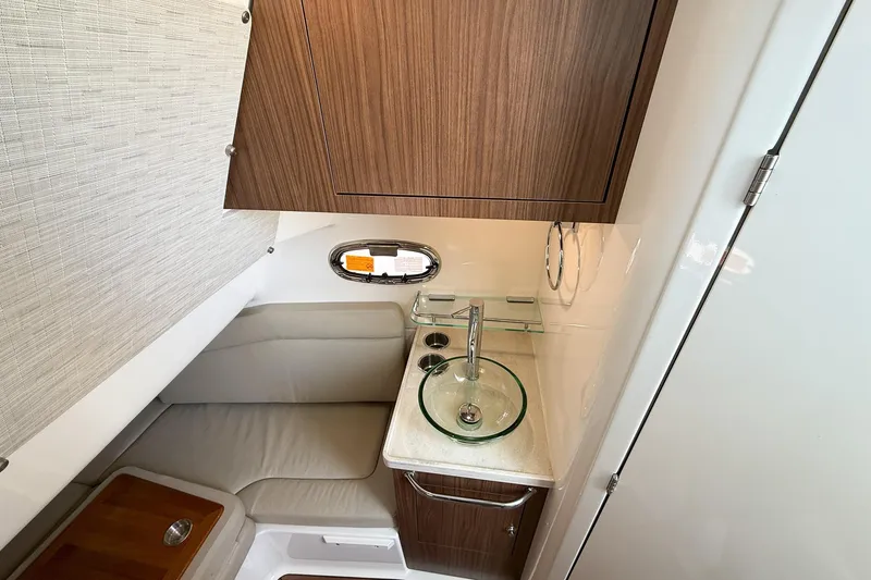 Slide: The Image of 2022 Boston Whaler 380 Outrage cabin with modern sink and seating area. - 52