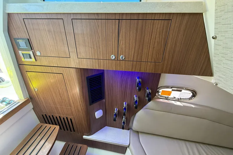 Slide: The Image of Interior of 2022 Boston Whaler 380 Outrage, featuring wood cabinetry and modern seating. - 55
