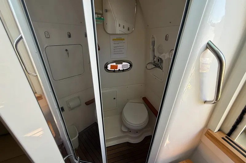 Slide: The Image of 2022 Boston Whaler 380 Outrage boat bathroom with modern amenities and compact design. - 57
