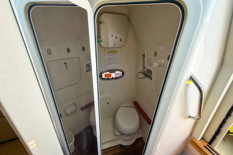 Slide: The Image of 2022 Boston Whaler 380 Outrage boat bathroom interior with toilet and shower. - 58
