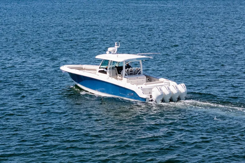 Slide: The Image of 2022 Boston Whaler 380 Outrage cruising on open water. - 6