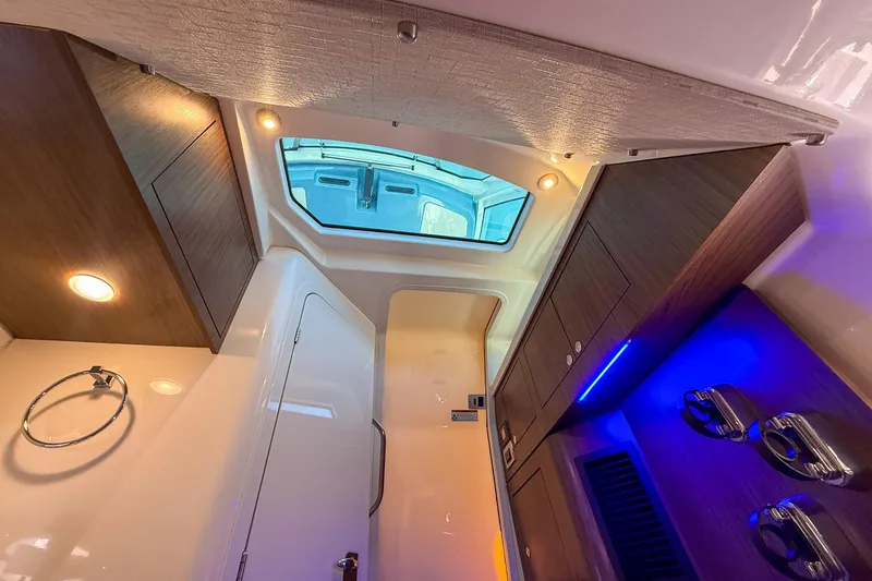 Slide: The Image of Luxurious interior of 2022 Boston Whaler 380 Outrage with modern lighting and wood finishes. - 63