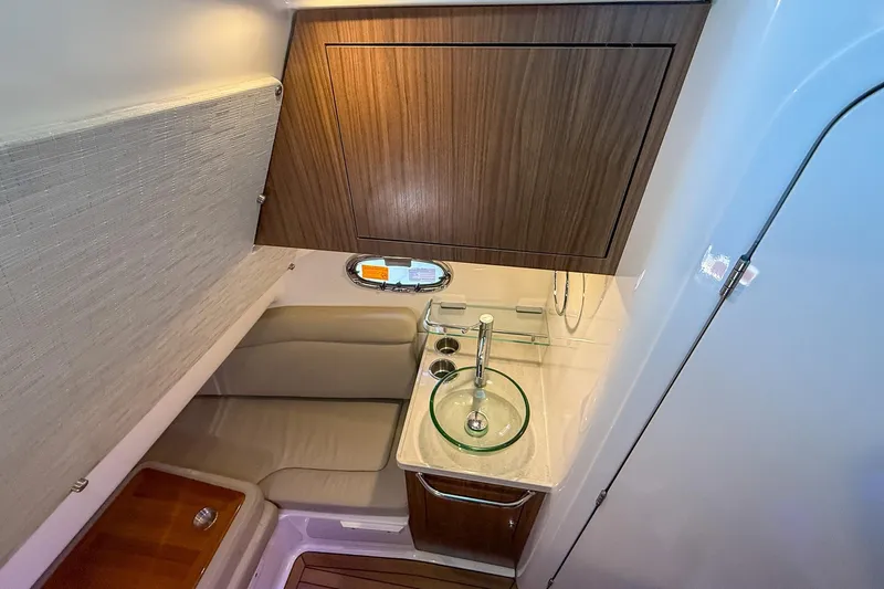 Slide: The Image of 2022 Boston Whaler 380 Outrage cabin interior with modern sink and seating area. - 69