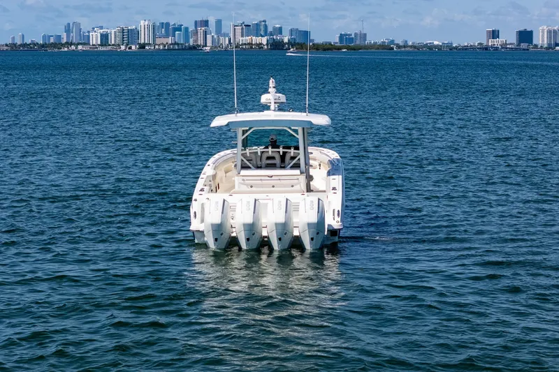 Slide: The Image of 2022 Boston Whaler 380 Outrage on water with city skyline in background. - 7