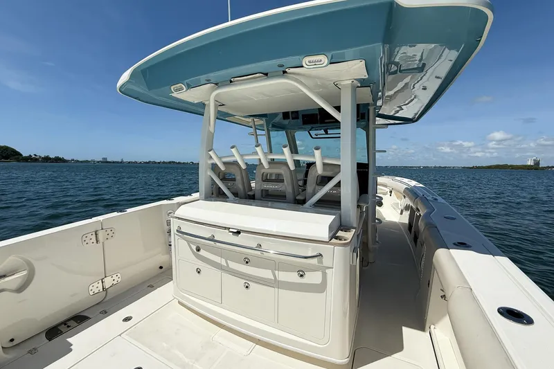 Slide: The Image of 2022 Boston Whaler 380 Outrage boat on open water, featuring spacious deck and seating. - 70
