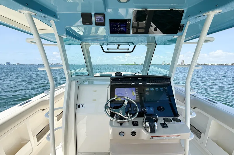 Slide: The Image of 2022 Boston Whaler 380 Outrage helm with advanced navigation system on open water. - 74