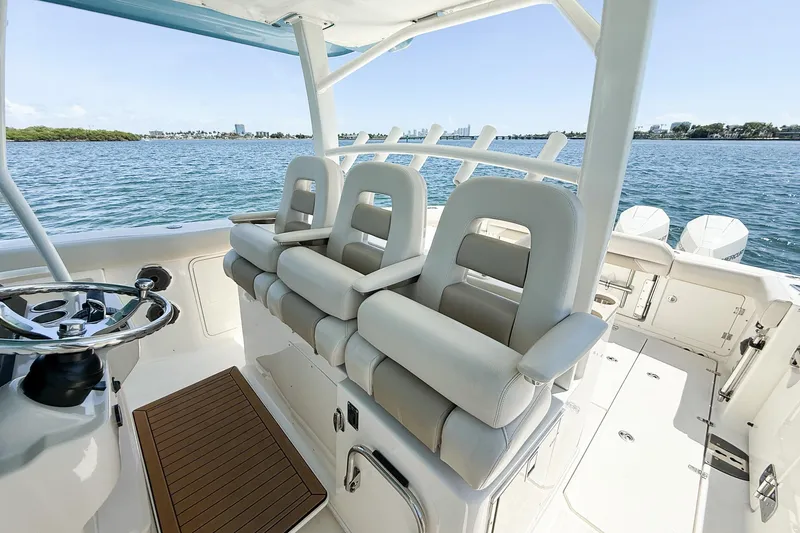 Slide: The Image of 2022 Boston Whaler 380 Outrage boat interior with helm seating and ocean view. - 76