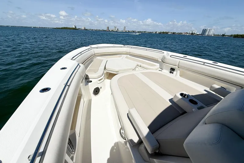 Slide: The Image of 2022 Boston Whaler 380 Outrage boat interior with luxurious seating on open water. - 77