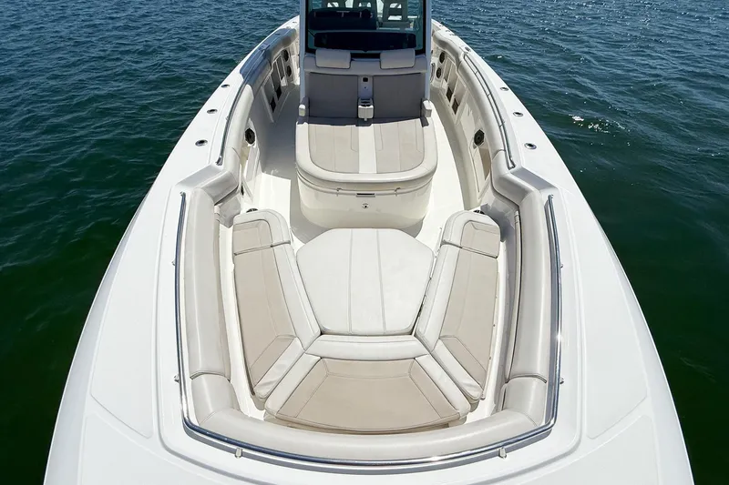 Slide: The Image of 2022 Boston Whaler 380 Outrage boat interior with cushioned seating on open water. - 78