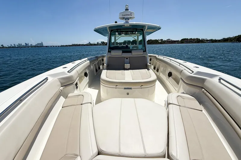 Slide: The Image of 2022 Boston Whaler 380 Outrage boat interior with seating, on calm water. - 80