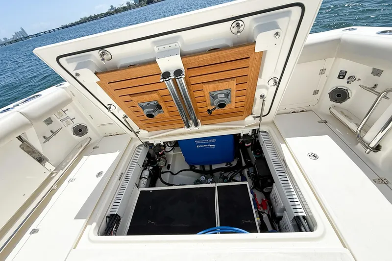 Slide: The Image of Boston Whaler 380 Outrage 2022 boat storage compartment open, revealing interior equipment. - 85