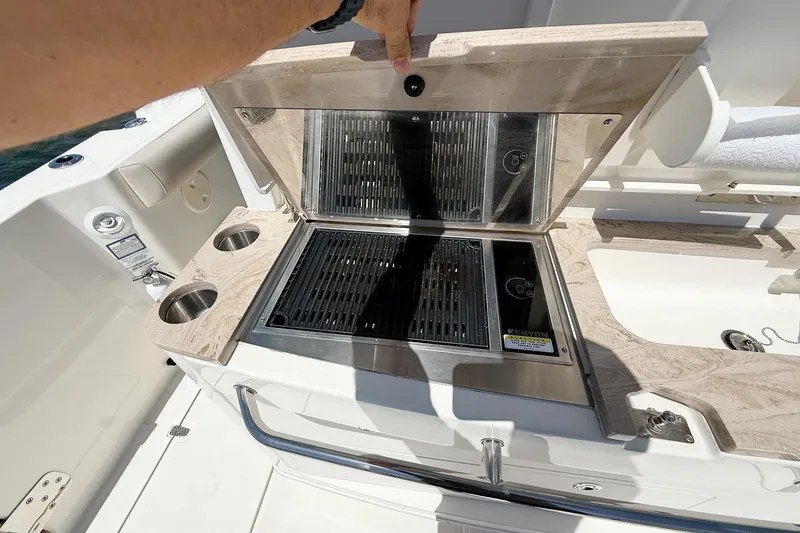 Slide: The Image of Outdoor grill on 2022 Boston Whaler 380 Outrage boat, featuring dual cup holders. - 89