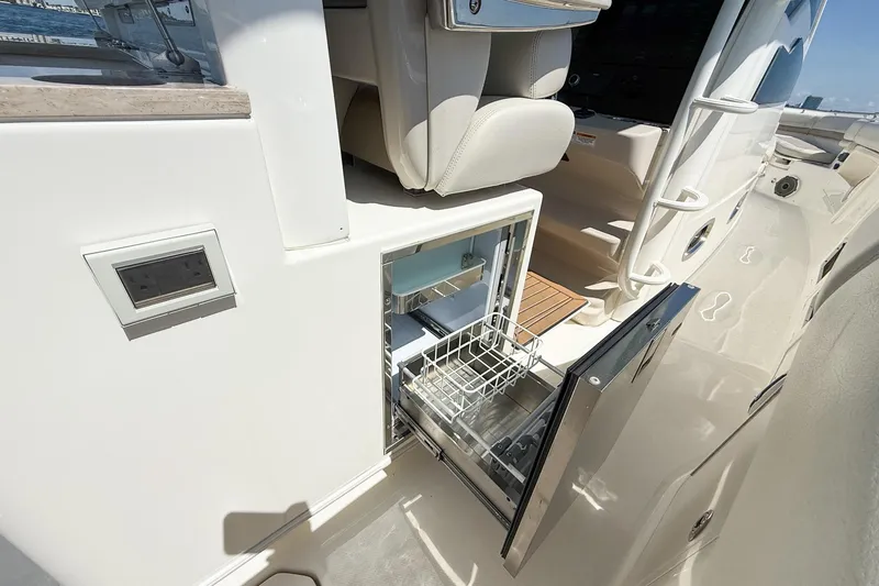 Slide: The Image of 2022 Boston Whaler 380 Outrage boat with open built-in storage compartment. - 94