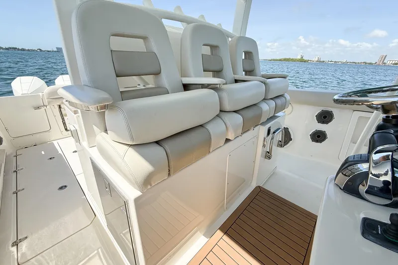 Slide: The Image of 2022 Boston Whaler 380 Outrage boat interior with luxurious seating and helm controls. - 97
