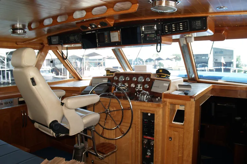 Slide: The Image of 1964 Striker Cockpit with wooden steering wheel, gauges, and captain's hats on the dashboard. - 12