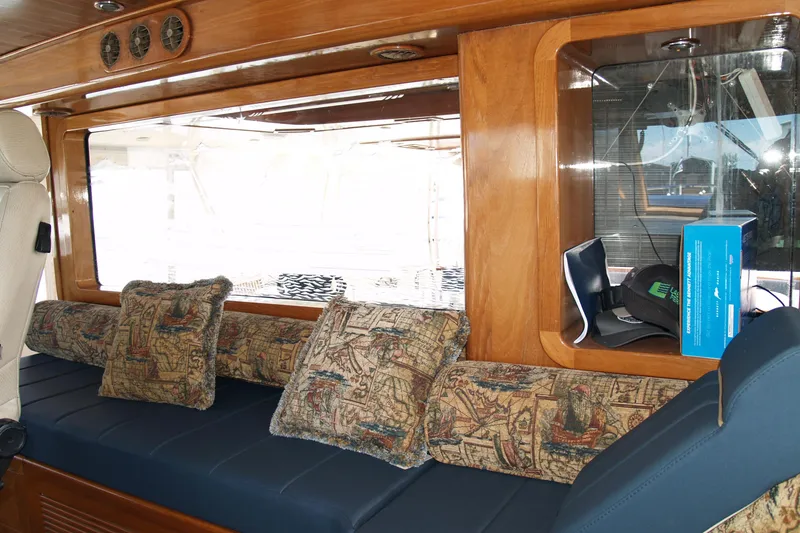 Slide: The Image of 1964 Striker Cockpit interior with plush seating, wooden cabinetry, and nautical steering wheel. - 15