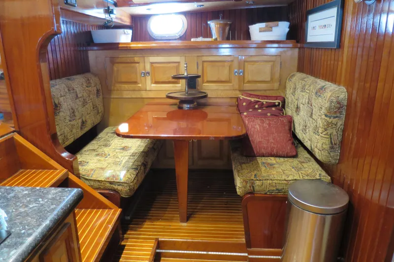 Slide: The Image of 1964 Striker Cockpit interior with wood paneling, cushioned seating, and nautical decor. - 20