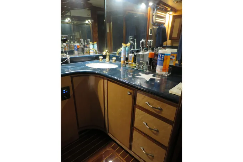Slide: The Image of Luxurious 1964 Striker Cockpit yacht kitchen with modern appliances and elegant wood cabinetry. - 27