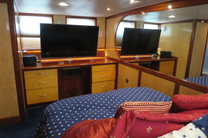 Slide: The Image of Cozy 1964 Striker Cockpit bedroom with star-patterned bedding and colorful pillows. - 29