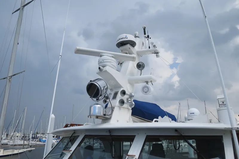 Slide: The Image of 1964 Striker Cockpit boat docked at marina, featuring blue covers and wooden deck. - 4