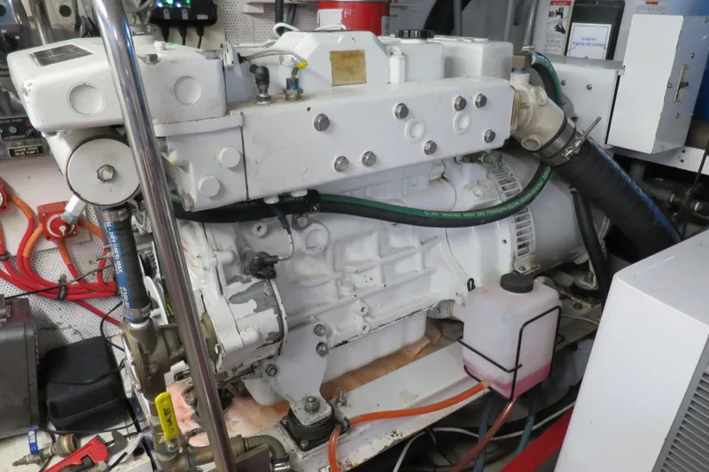 Slide: The Image of Engine room of a 1964 Striker Cockpit boat with complex machinery and piping. - 42