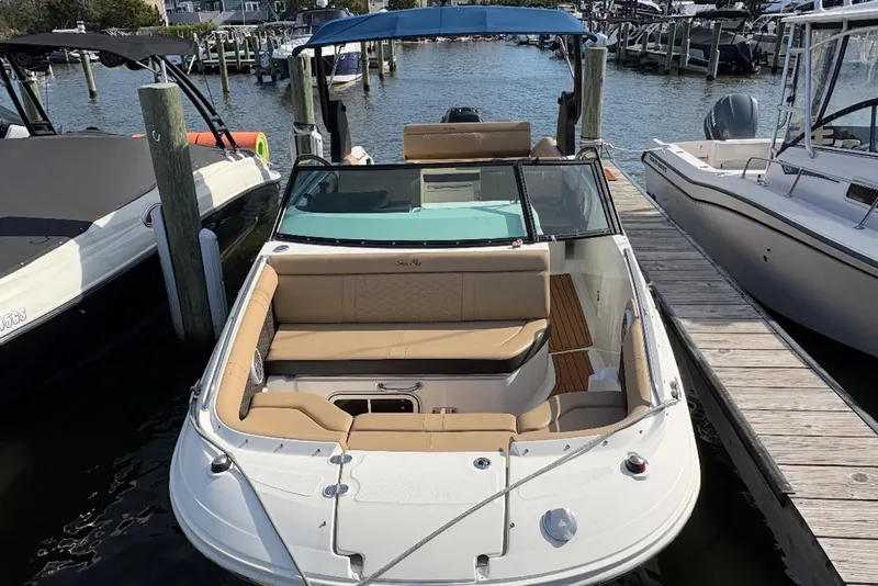 Slide: The Image of 2018 Sea Ray SDX 250 Outboard docked, featuring spacious seating and sleek design. - 13
