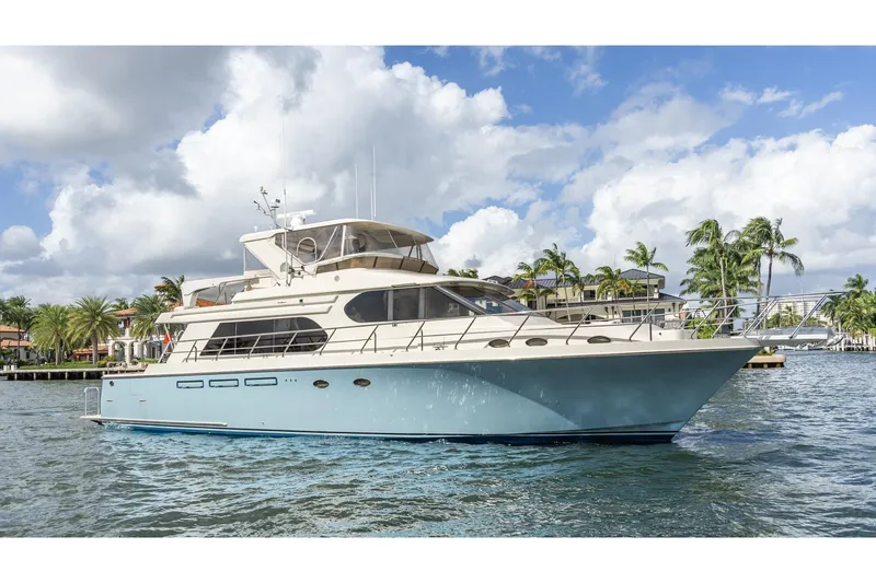 The Image of 2005 Ocean Alexander Raised Pilothouse Flybridge Sedan yacht on water, with palm trees in background. - 0