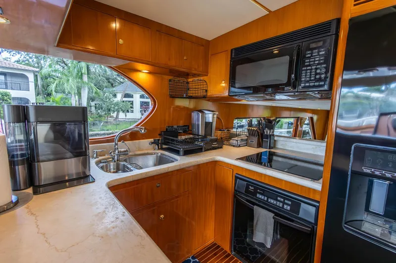 Slide: The Image of Luxurious 2005 Ocean Alexander yacht kitchen with modern appliances and elegant wood cabinetry. - 11